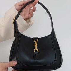 Black Classic Curved Leather Handbag with Signature Buckle Closure